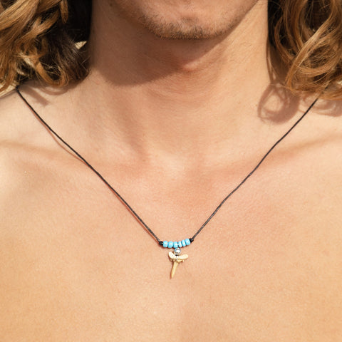 fossil shark tooth necklace on surfer australia