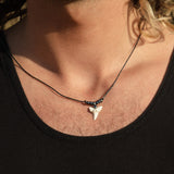 Mako shark tooth necklace in gunmetal grey worn by a male model