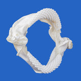 Genuine Pelagic Stingray jaws (Pteroplatytrygon violacea) showing distinctive curved jaw structure and rows of small teeth, photographed against a blue background.